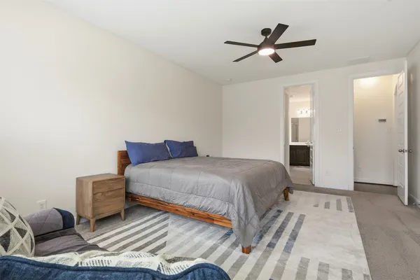 a bedroom with a bed and a large window with the outer view