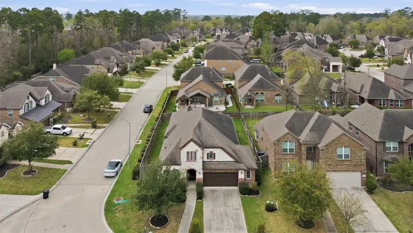 an aerial view of multiple houses with yard