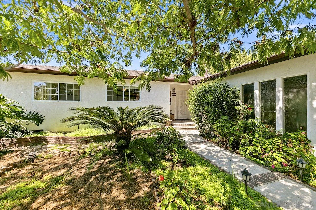 2602 Murray Ridge Road San Diego, CA 92123 - Photo 2 of 17 a house that has a tree in front of it