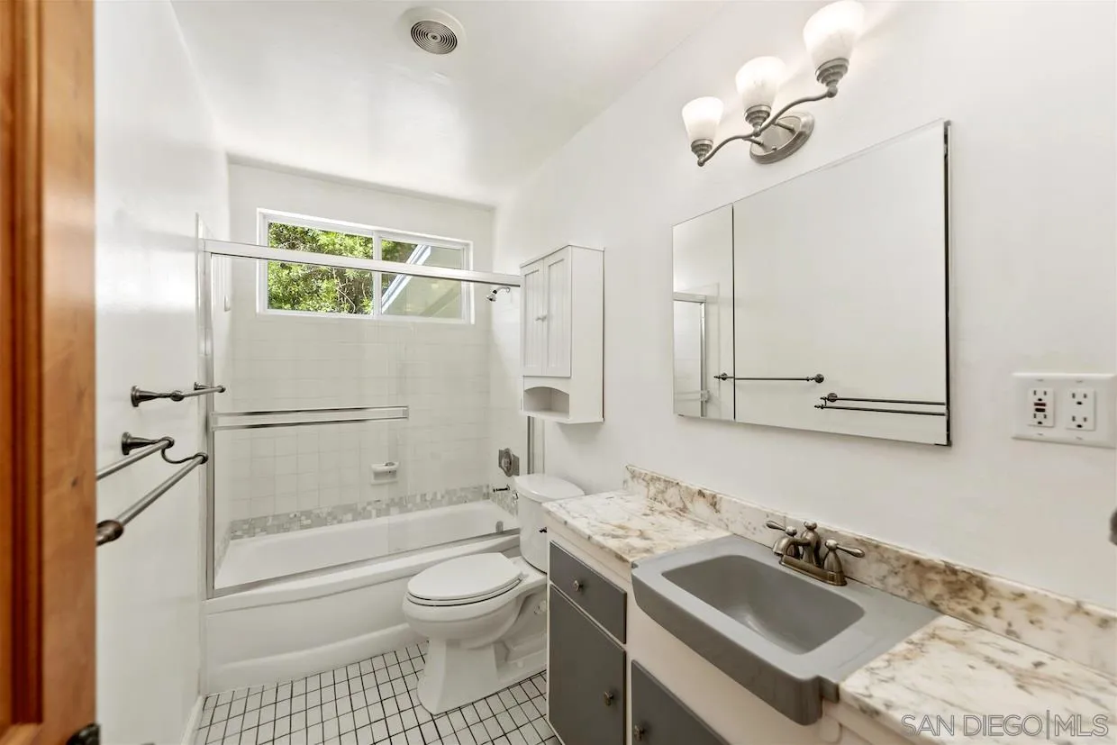 2602 Murray Ridge Road San Diego, CA 92123 - Photo 5 of 17 a bathroom with a sink toilet tub and shower