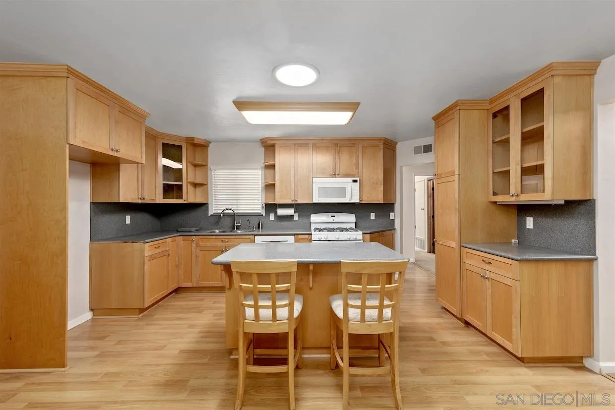 2602 Murray Ridge Road San Diego, CA 92123 - Photo 7 of 17 a large kitchen with a table and chairs in it