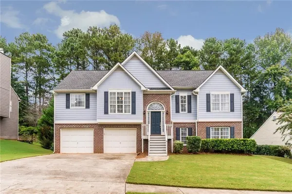 a front view of a house with a yard and garage