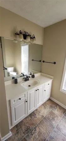 a living room with furniture a refrigerator and a table