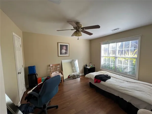 a balcony with wooden floor and yard in the back