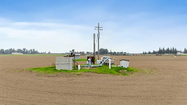 a view of a lake with lawn chairs