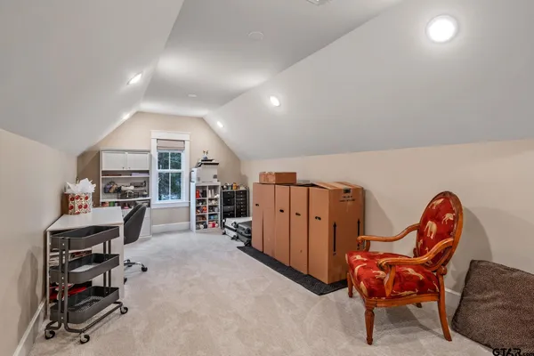a view of a house with backyard and a trees