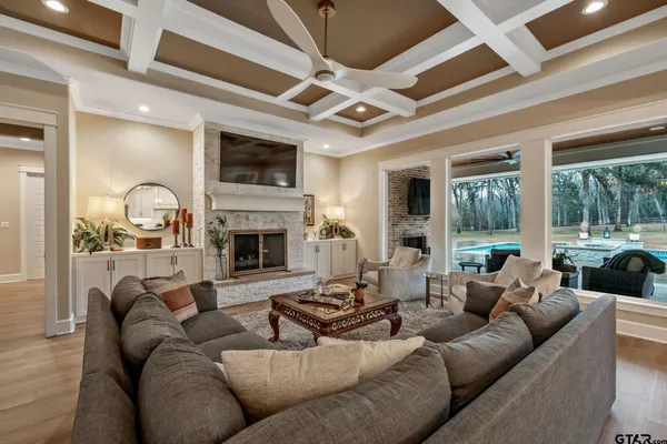 a living room with furniture fireplace and a large window