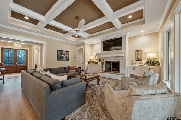 a living room with furniture a flat screen tv and a fireplace