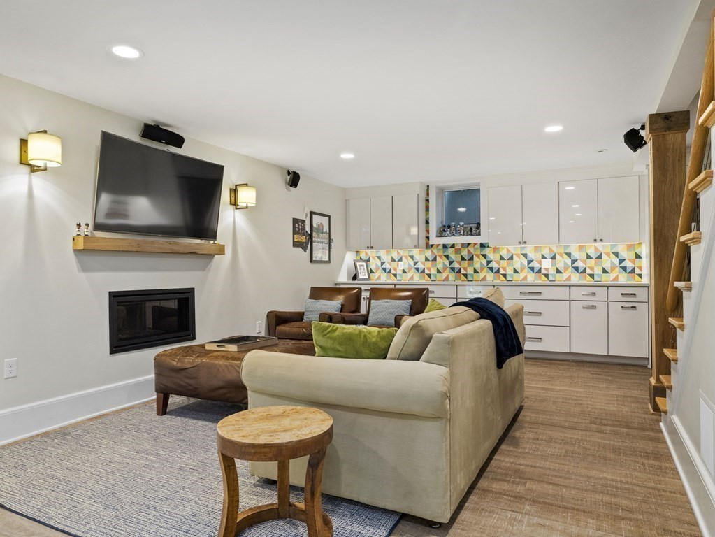 60 Damien Road Wellesley, MA 02481 - Photo 22 of 36 a living room with furniture a fireplace and a flat screen tv