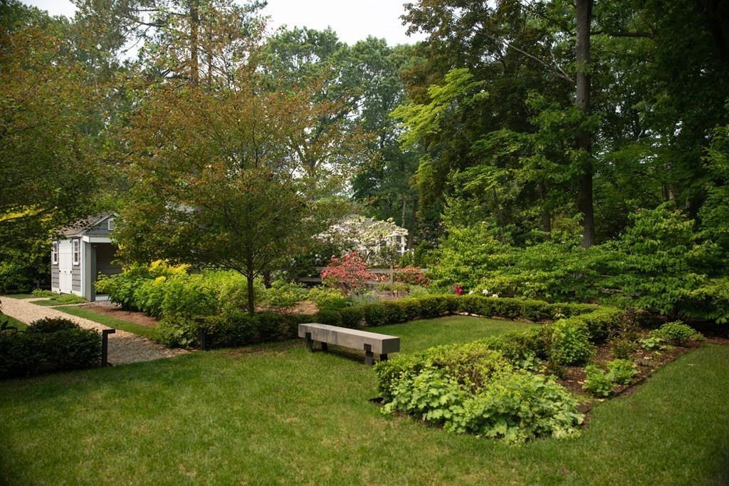 60 Damien Road Wellesley, MA 02481 - Photo 30 of 36 a view of a garden with a bench