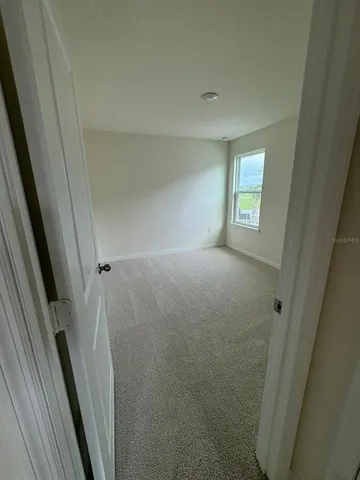 a view of room with window and stairs