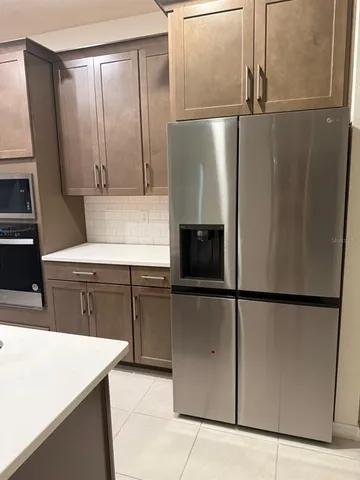 a kitchen with a refrigerator and a sink