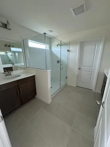 a bathroom with a double vanity sink toilet and mirror