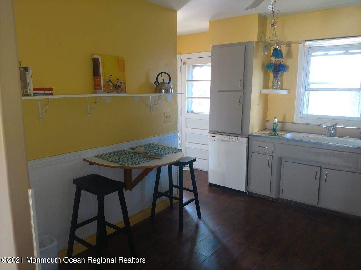 3 Midpark Drive Brick, NJ 08724 - Photo 6 of 12 a kitchen with stainless steel appliances a table chairs in it and a window