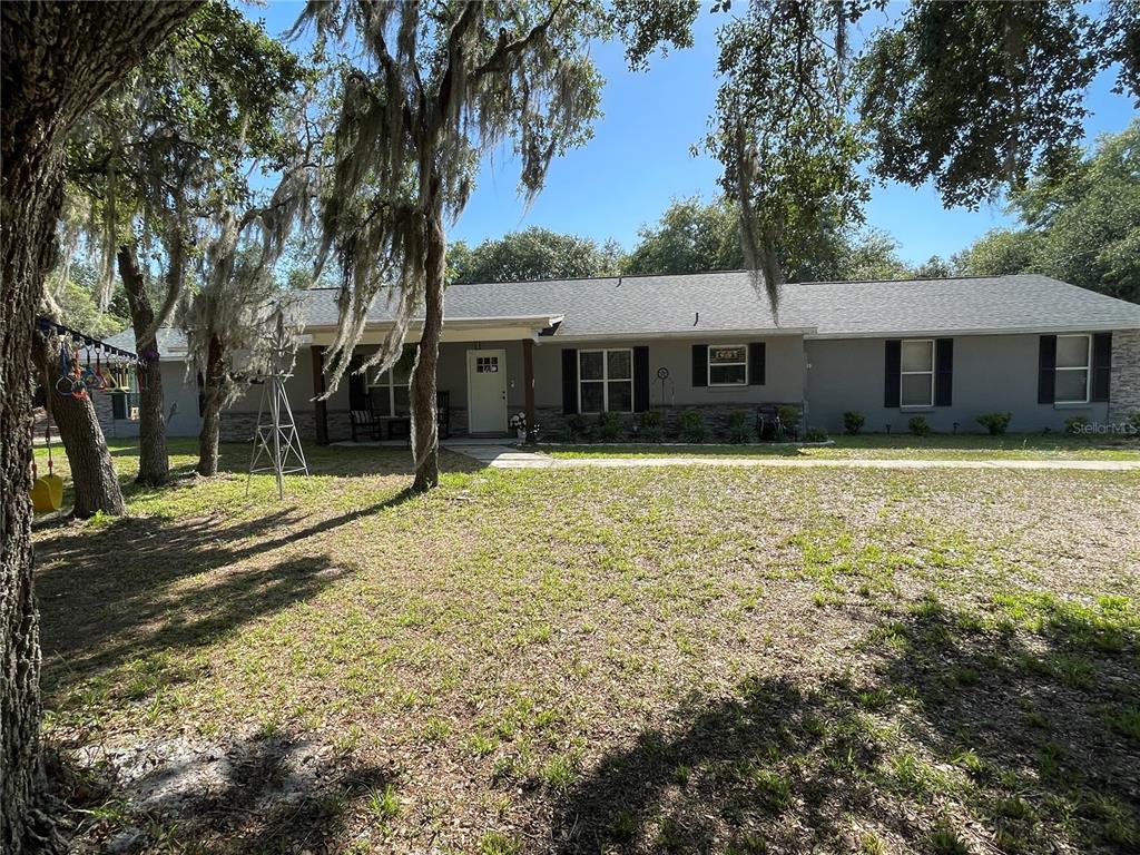 a view of a house with pool and tree s