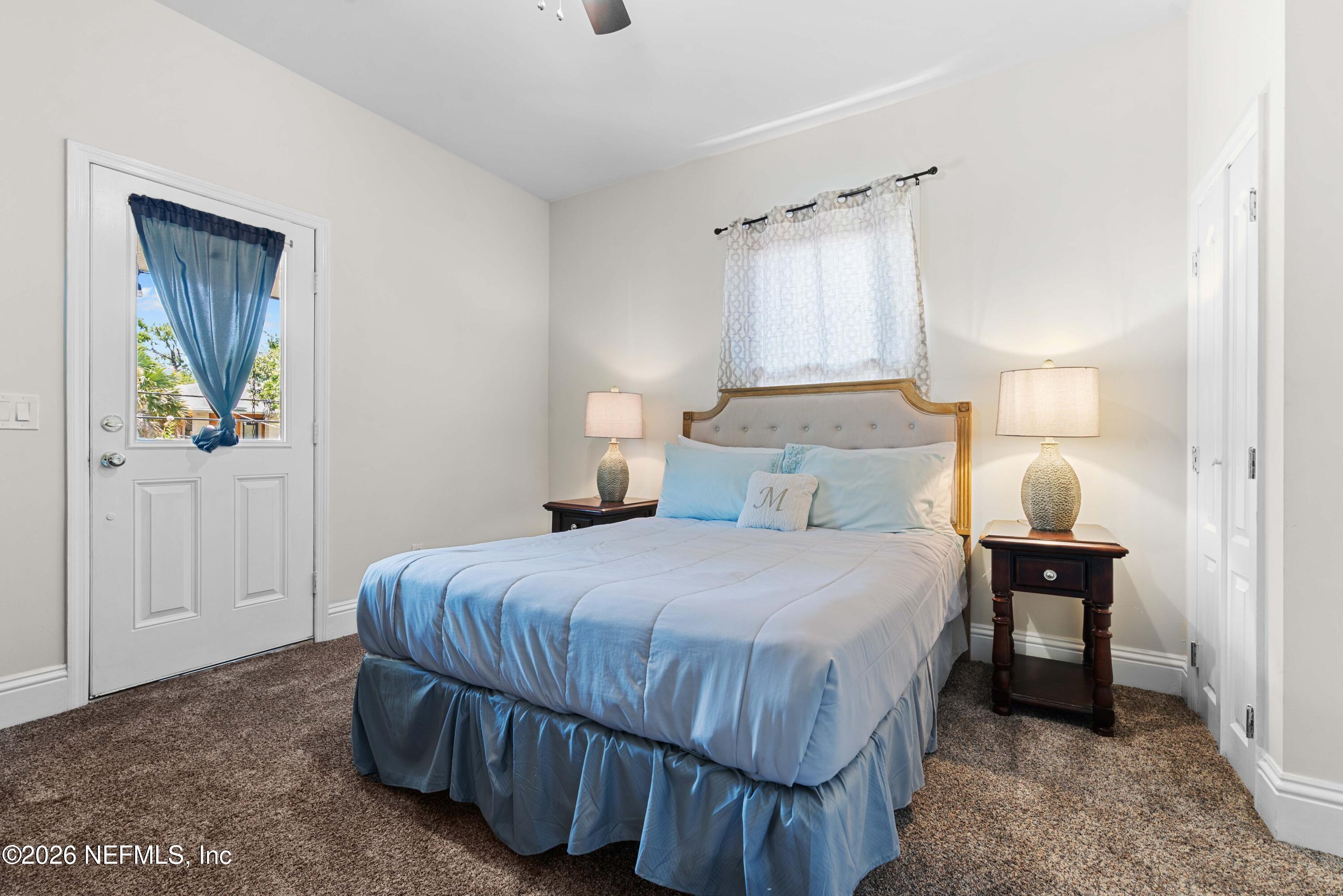1138 Walnut Street Jacksonville, FL 32206 - Photo 36 of 37 a bedroom with a bed lamp and a window