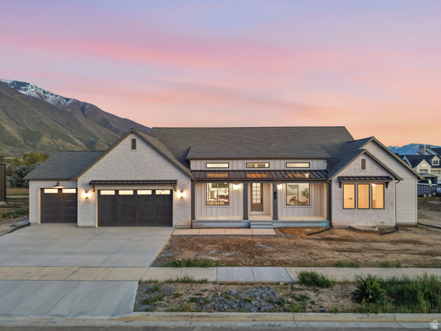 161 West 250 S Street South Mapleton, UT 84664 - Photo 1 of 1 Modern inspired farmhouse with covered porch, a standing seam roof, a garage, concrete driveway, and board and batten siding