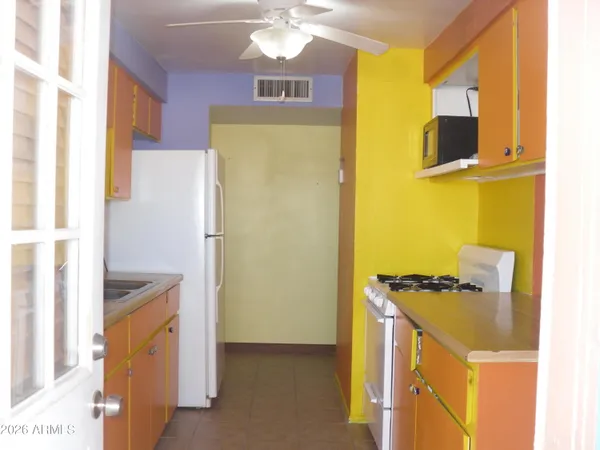 a kitchen with a refrigerator and a stove