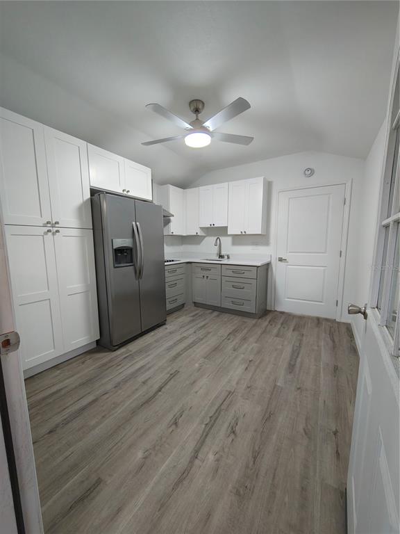 820 North Wekiwa Springs Road Apopka, FL 32712 - Photo 14 of 51 a room with a refrigerator and a sink