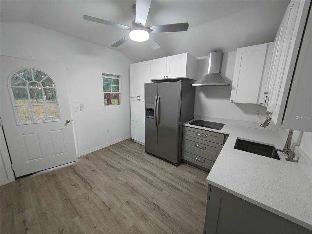 820 North Wekiwa Springs Road Apopka, FL 32712 - Photo 15 of 51 a kitchen with a refrigerator cabinet and a sink