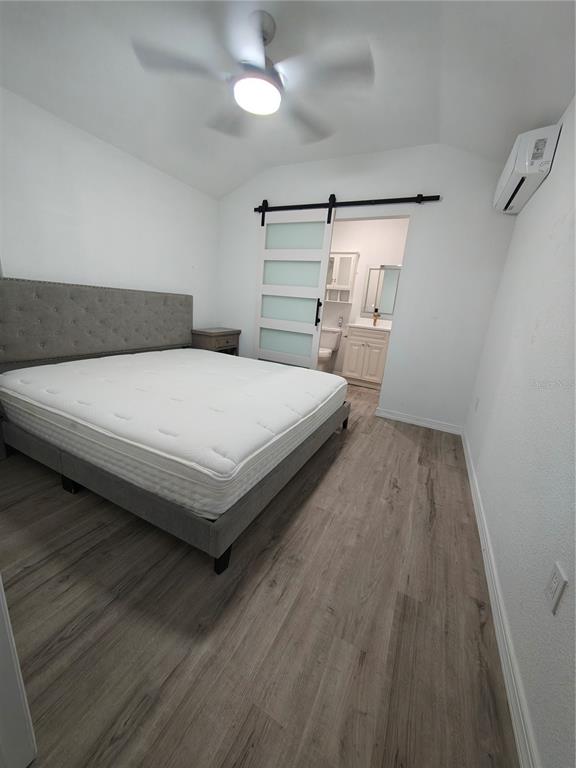 820 North Wekiwa Springs Road Apopka, FL 32712 - Photo 16 of 51 a bedroom with a bed and wooden floor