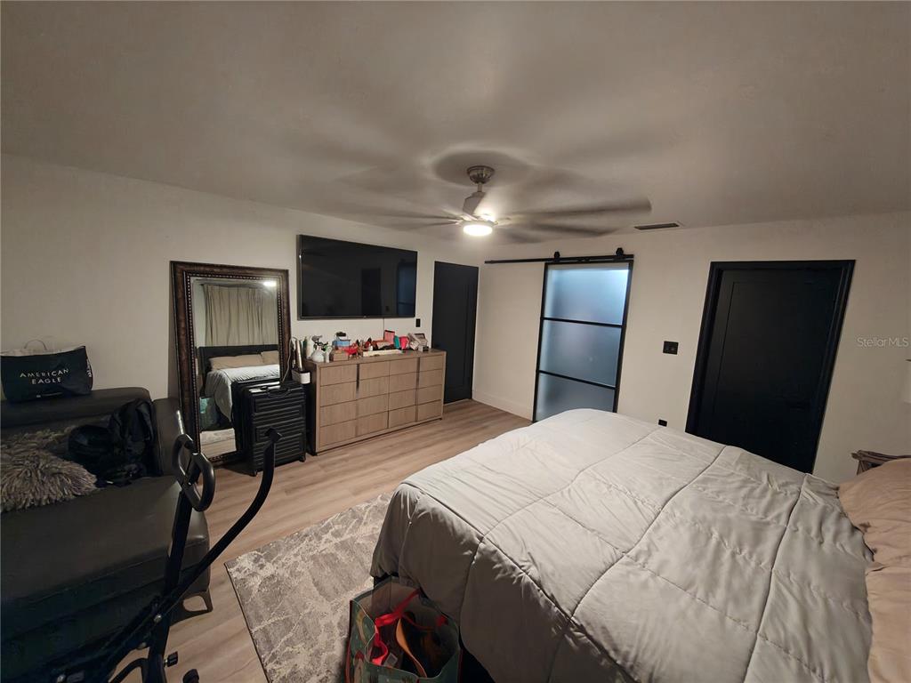 820 North Wekiwa Springs Road Apopka, FL 32712 - Photo 27 of 51 a bedroom with a bed and a flat tv screen on a dresser