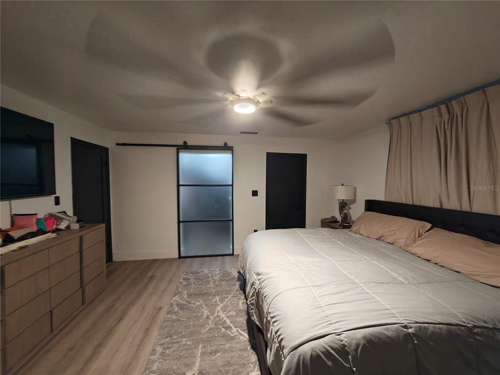 820 North Wekiwa Springs Road Apopka, FL 32712 - Photo 28 of 51 a bedroom with a bed and a flat screen tv