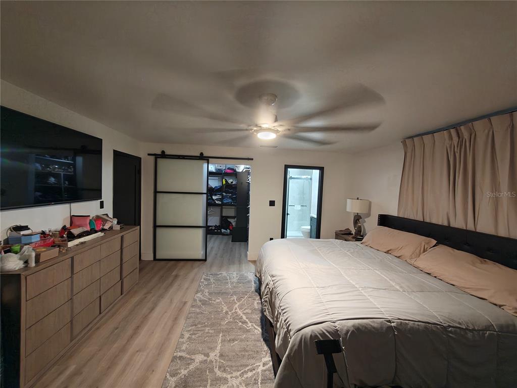 820 North Wekiwa Springs Road Apopka, FL 32712 - Photo 29 of 51 a bedroom with a bed and a flat screen tv