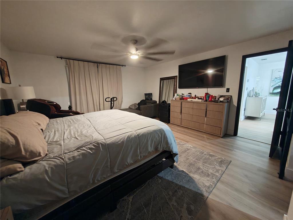 820 North Wekiwa Springs Road Apopka, FL 32712 - Photo 30 of 51 a bedroom with a bed and a flat screen tv