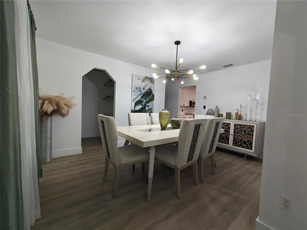 820 North Wekiwa Springs Road Apopka, FL 32712 - Photo 33 of 51 a dining room with furniture a chandelier and wooden floor