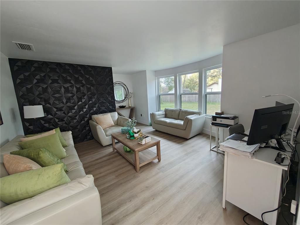 820 North Wekiwa Springs Road Apopka, FL 32712 - Photo 36 of 51 a living room with furniture and a flat screen tv