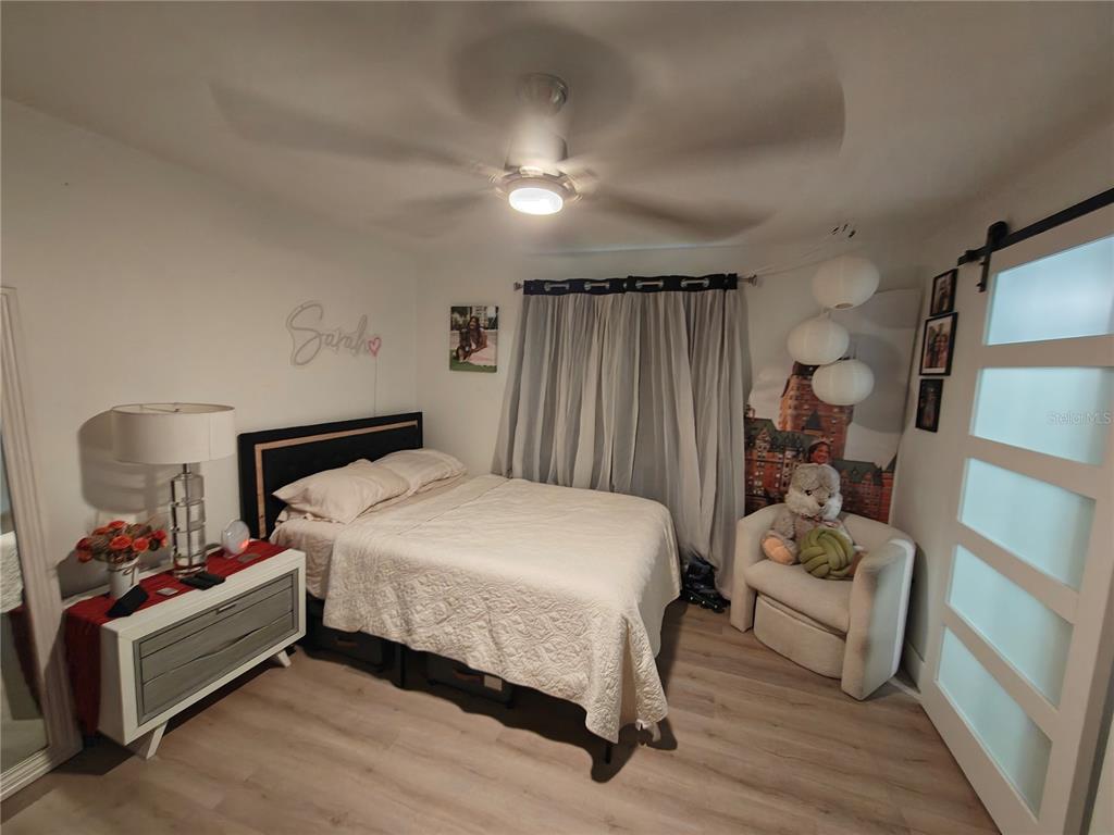 820 North Wekiwa Springs Road Apopka, FL 32712 - Photo 40 of 51 a bedroom with a bed and wooden floor