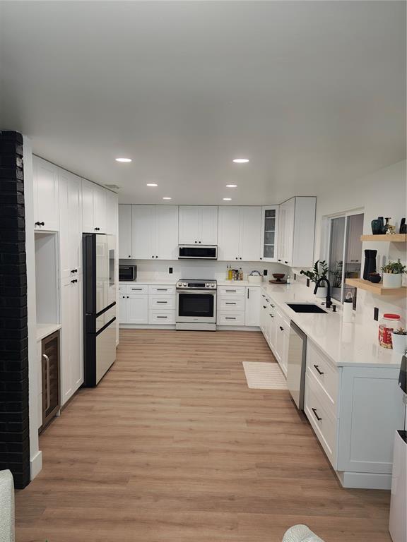 820 North Wekiwa Springs Road Apopka, FL 32712 - Photo 9 of 51 a large kitchen with stainless steel appliances and a refrigerator