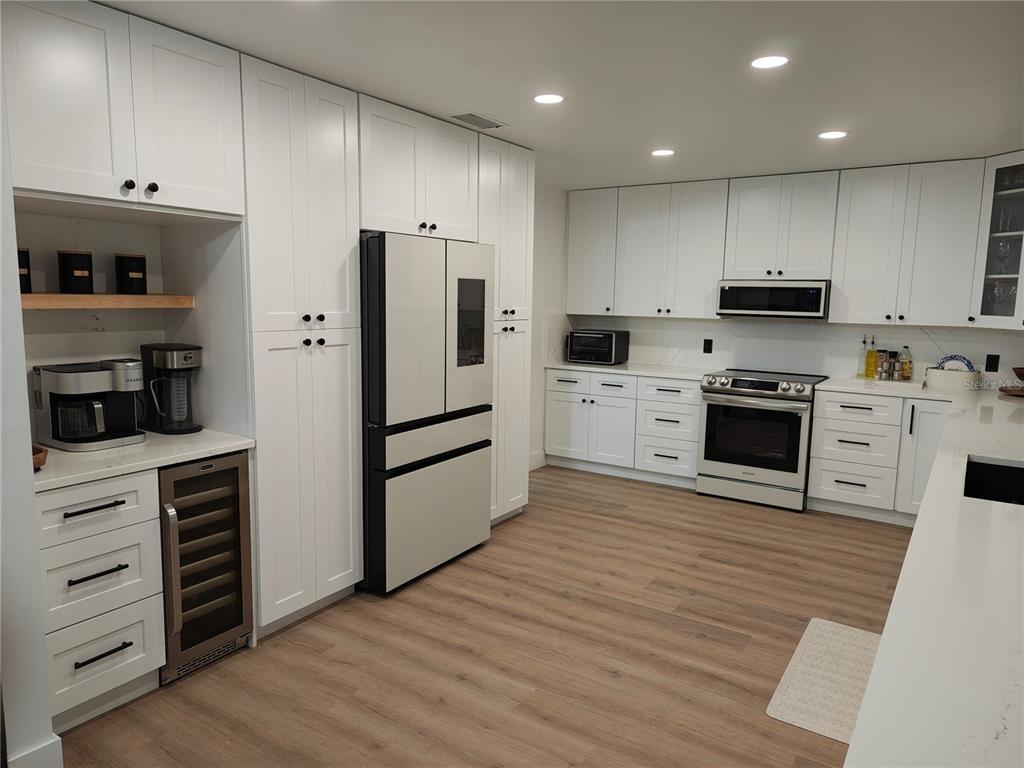820 North Wekiwa Springs Road Apopka, FL 32712 - Photo 10 of 51 a kitchen with granite countertop white cabinets and stainless steel appliances