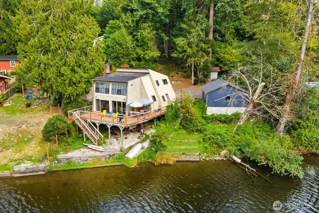 an aerial view of a house with a ocean view