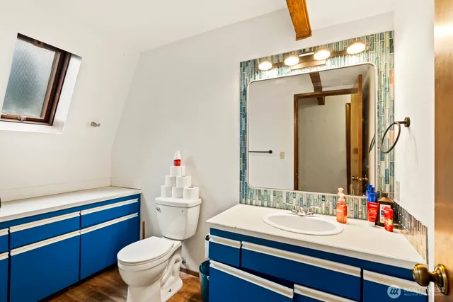a bathroom with a sink a toilet and mirror