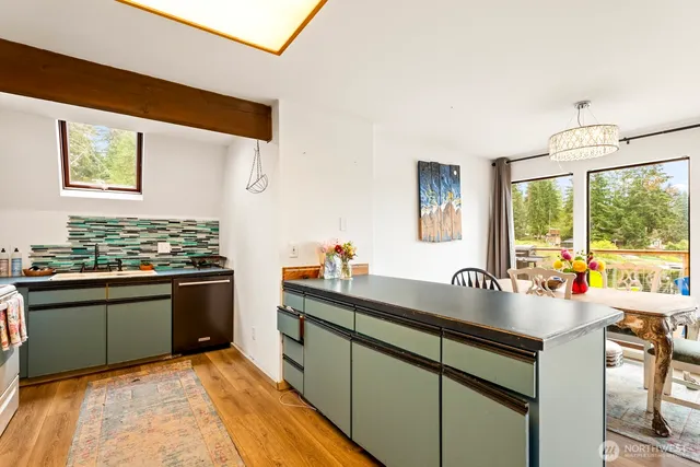 a kitchen with stainless steel appliances granite countertop a sink stove and cabinets