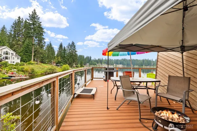 a view of a balcony with chairs and wooden floor