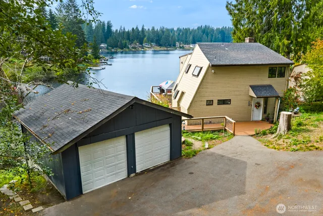a aerial view of a house with swimming pool and lake view