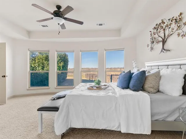 a bedroom with a large bed and a large window