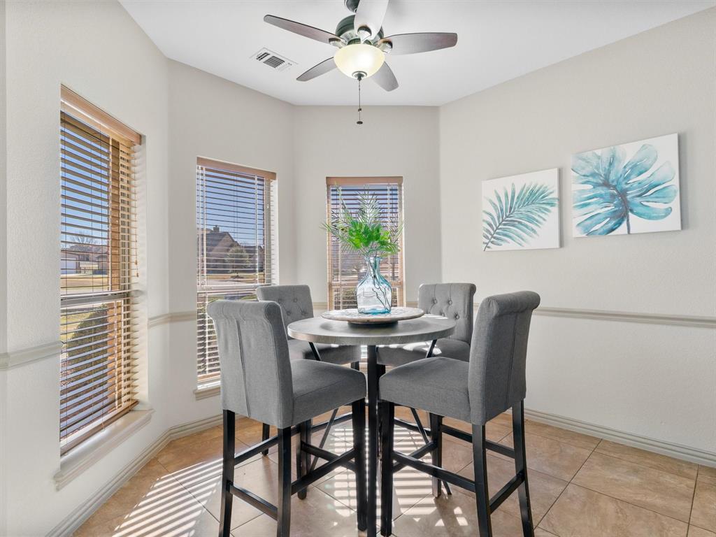 1311 Roe Helm Drive Rhome, TX 76078 - Photo 19 of 35 Breakfast nook with room for 4-6 right in the kitchen, with a bay window for beautiful views and loads of natural light