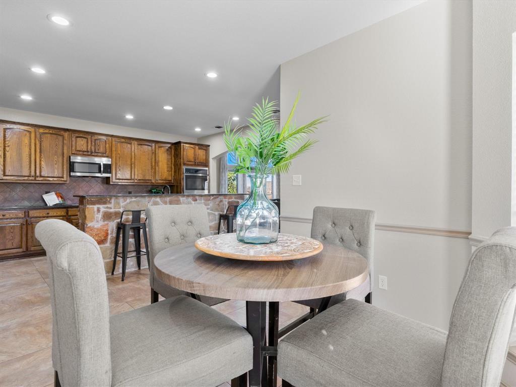 1311 Roe Helm Drive Rhome, TX 76078 - Photo 20 of 35 Breakfast nook with room for 4-6 right in the kitchen, with a bay window for beautiful views and loads of natural light