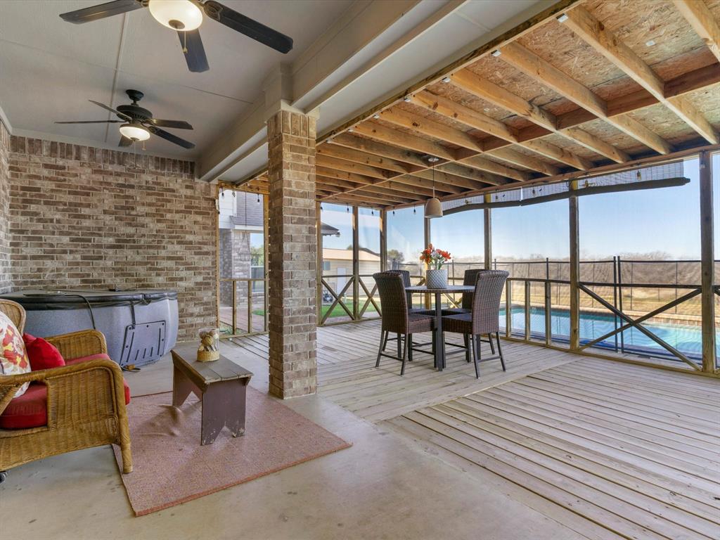 1311 Roe Helm Drive Rhome, TX 76078 - Photo 26 of 35 Covered back patio with cooling fans and a perfect spot to host a party