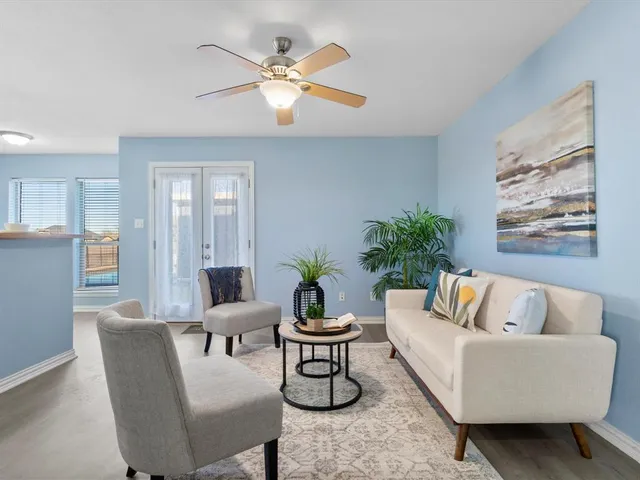 a living room with furniture and a large window