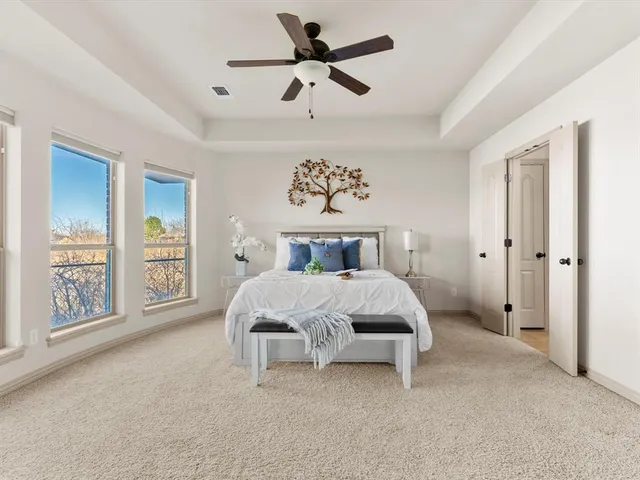 a bedroom with a bed dresser and a window