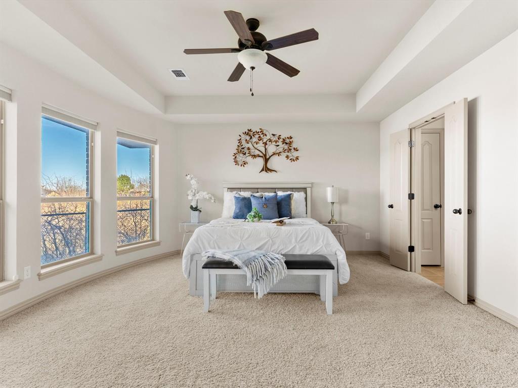 1311 Roe Helm Drive Rhome, TX 76078 - Photo 10 of 35 Beautiful primary bedroom with large picture windows and a view of the pool