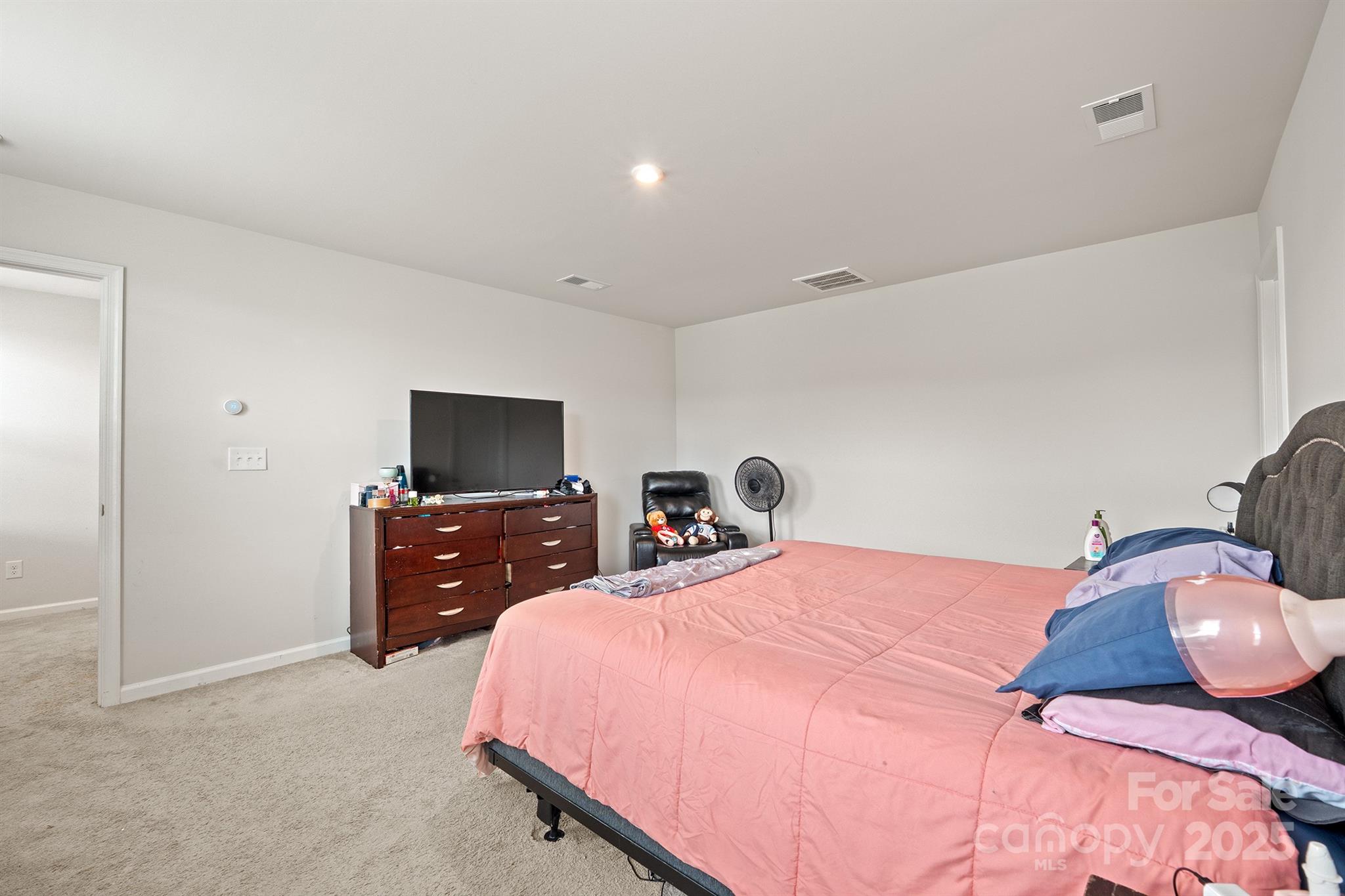 707 Point Andrews Drive Southwest Concord, NC 28025 - Photo 16 of 24 a bedroom with a bed and a flat screen tv