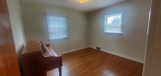 a view of room with window and wooden floor
