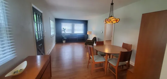 a view of a dining room with furniture and a chandelier