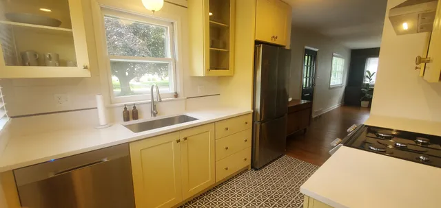 a kitchen with a sink and a refrigerator
